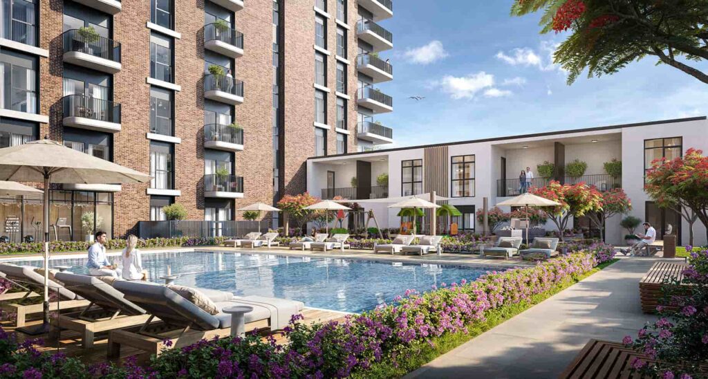 Modern apartment complex featuring a luxurious outdoor pool surrounded by blooming flowers and shaded lounge areas for relaxation.